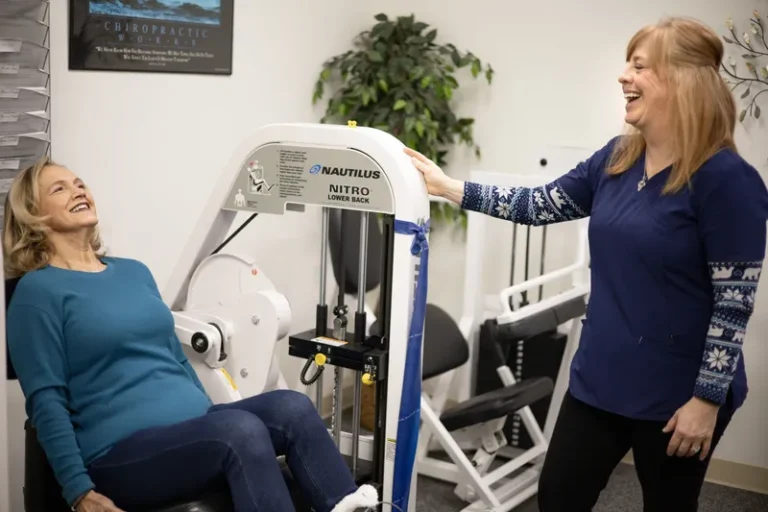 A patient doing a physical therapy exercise in a specific organ with the attendance of a physical therapist.