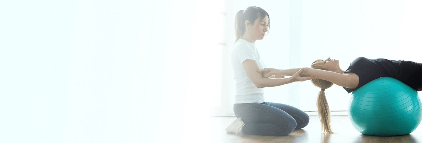 A physical therapist facilitating exercises to a patient.