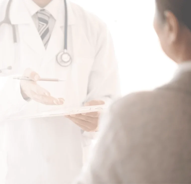 A doctor explaining his findings on his tablet to a patient.