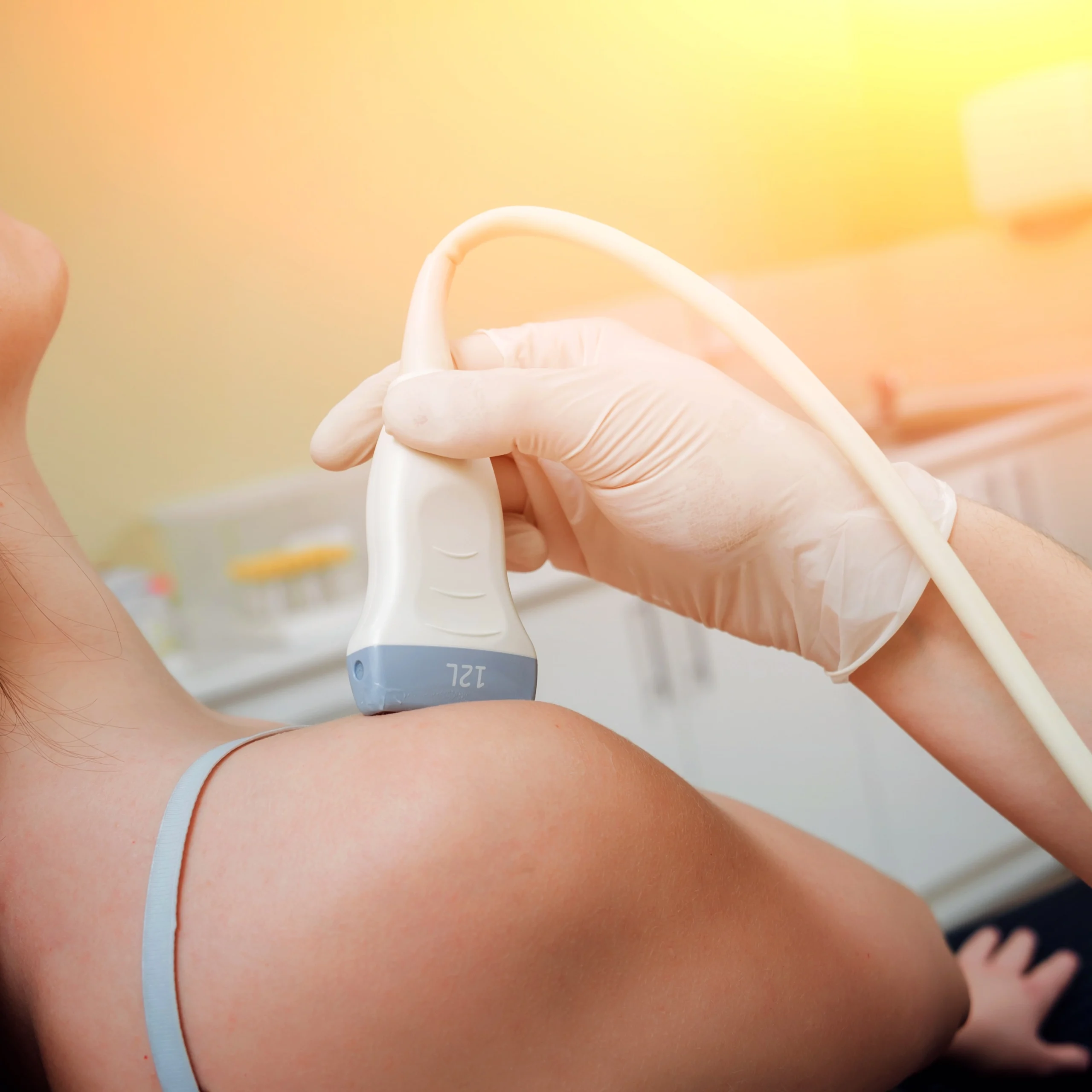 A woman having ultrasound in her shoulder.