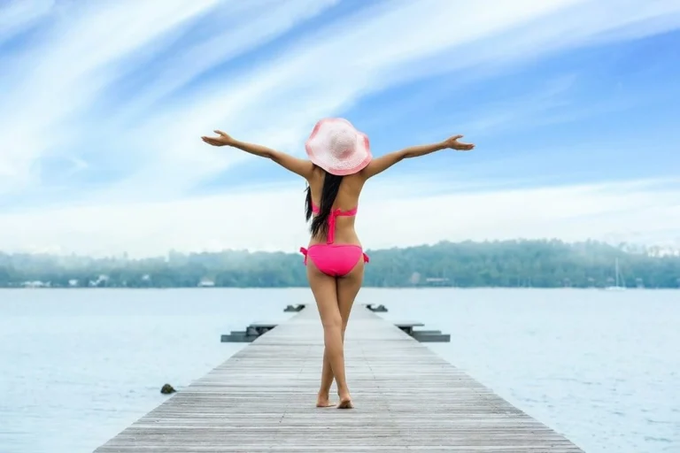 Woman joyfully looking at the sky in a pier.