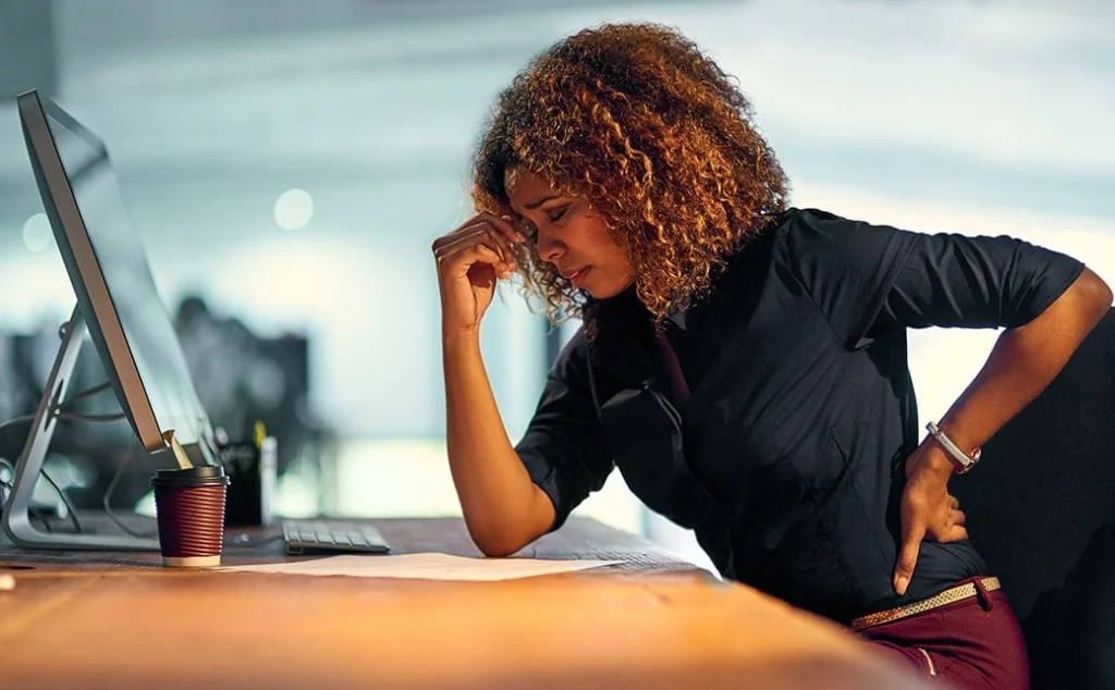 A woman stressed in front of her computer.