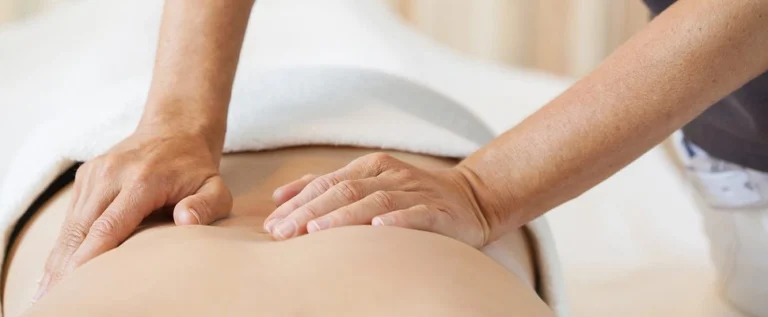 A patient's back being treated by a chiropractor.