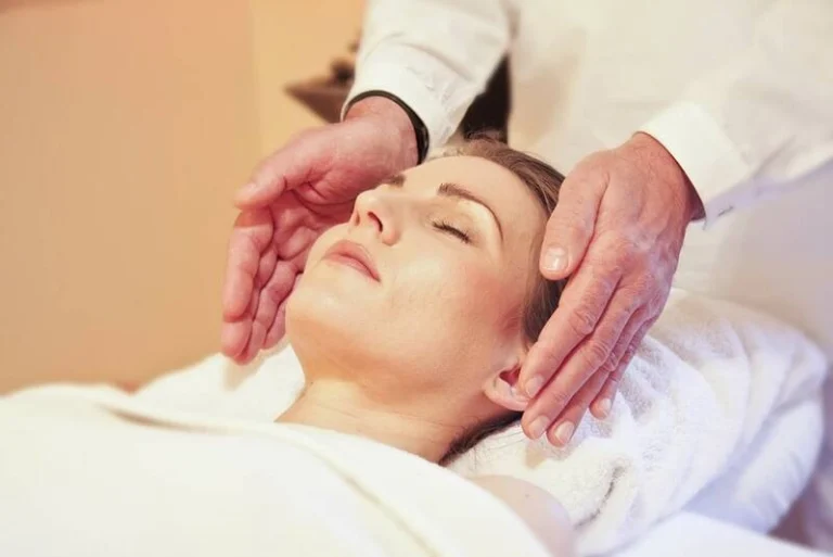 A woman having a relaxing massage to her face.