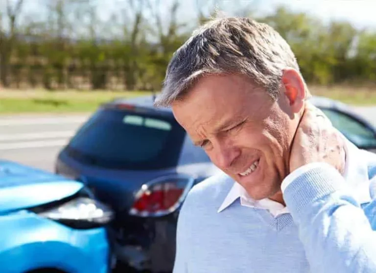 A man touching his neck in pain.