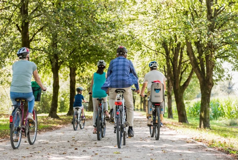 A group of people of all ages riding bicycles.