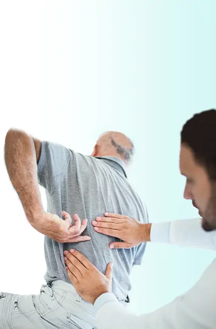 A chiropractor examines a patient's lower back.