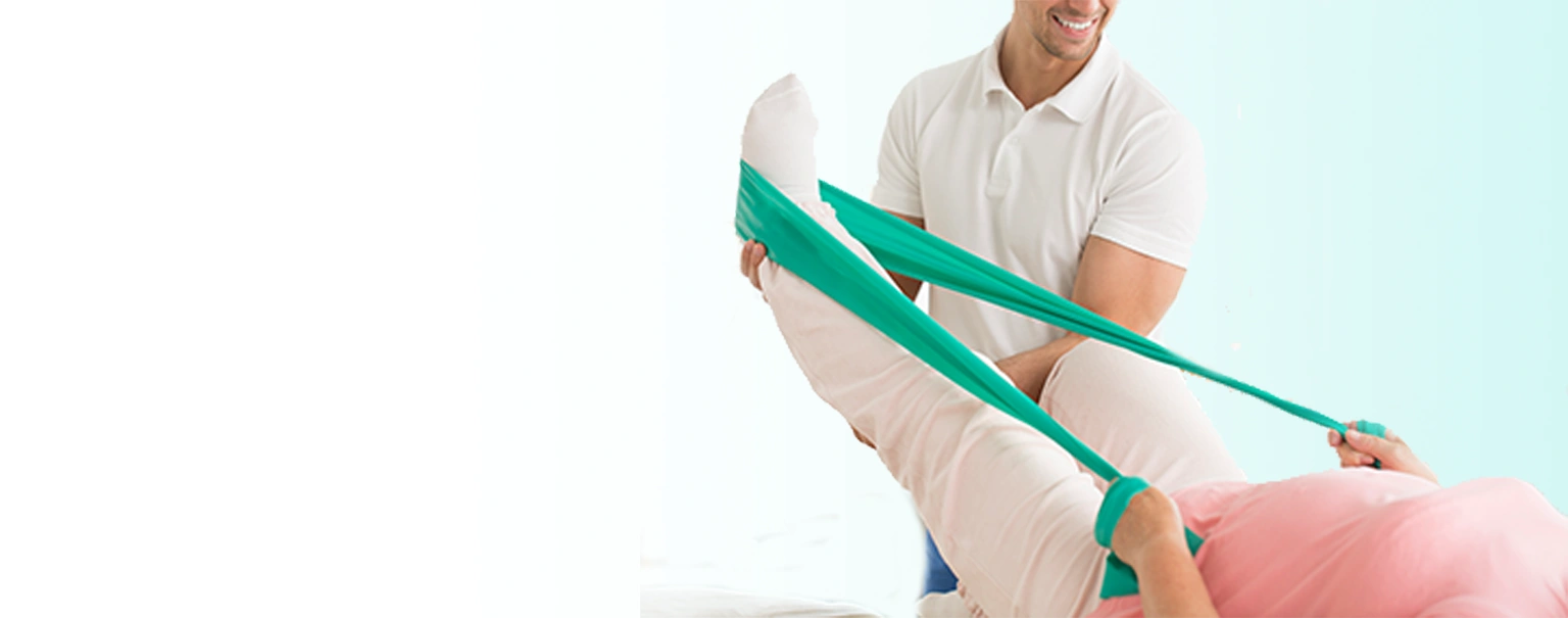 A chiropractor providing guidance in a specific exercise with rubber tension on a patient's sprained foot.