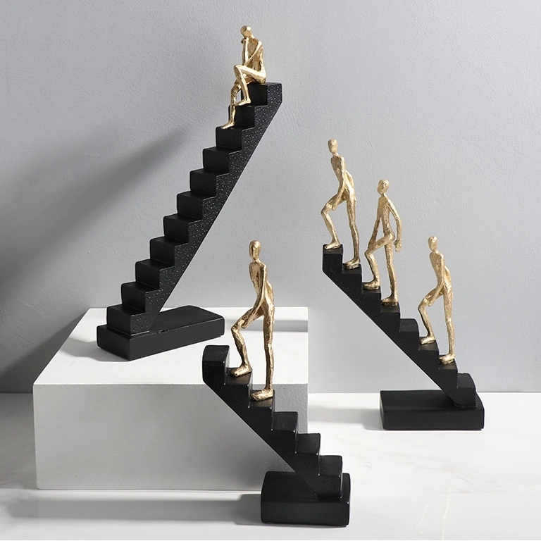 Gold Man Climbing Black Stairs Figurine